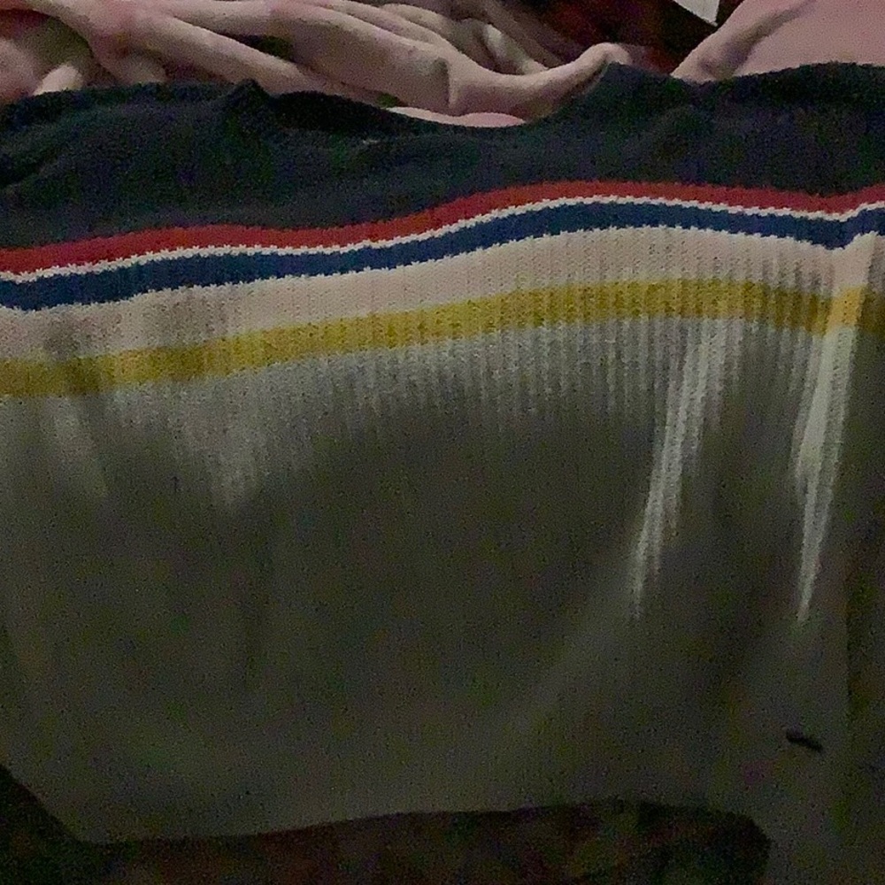 Has been worn multiple times and has a bit of fuzz on it.